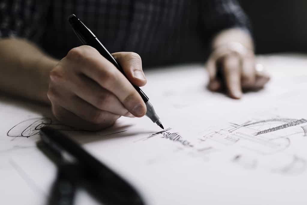 Close-up of architect hand sketching detailed architectural line drawing