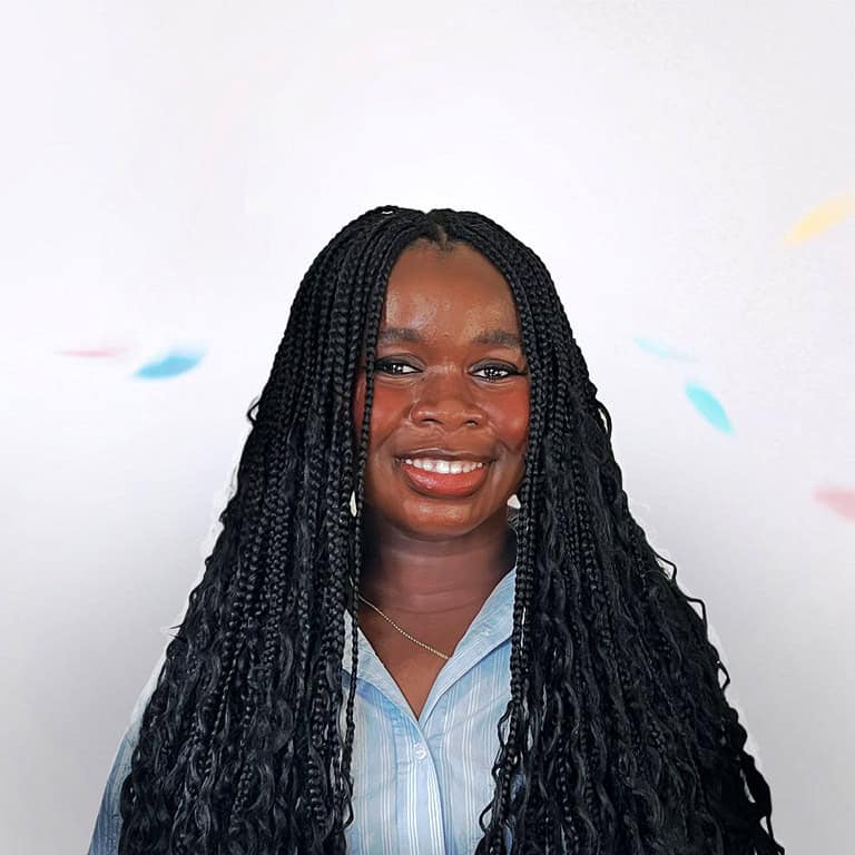Professional headshot of architect with braided hair smiling