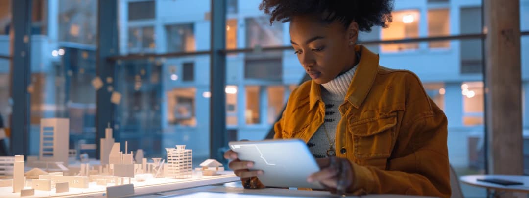 A young architect reviewing her drawings on an iPad