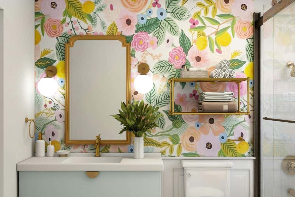 Vibrant floral wallpaper in contemporary bathroom interior with gold-framed mirror and marble vanity