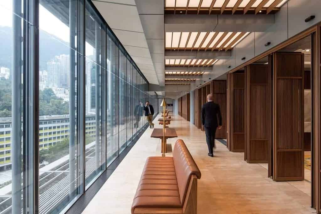 Warm timber-clad interior corridor of HSBC Hong Kong offices with panoramic city views