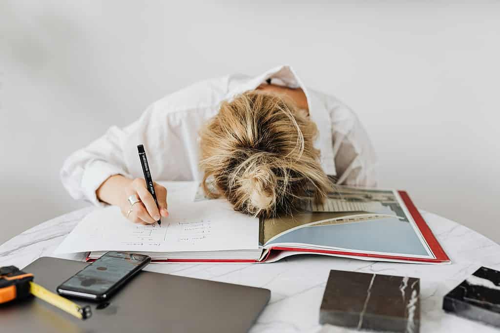 Professional woman reviewing documents at desk in home office
