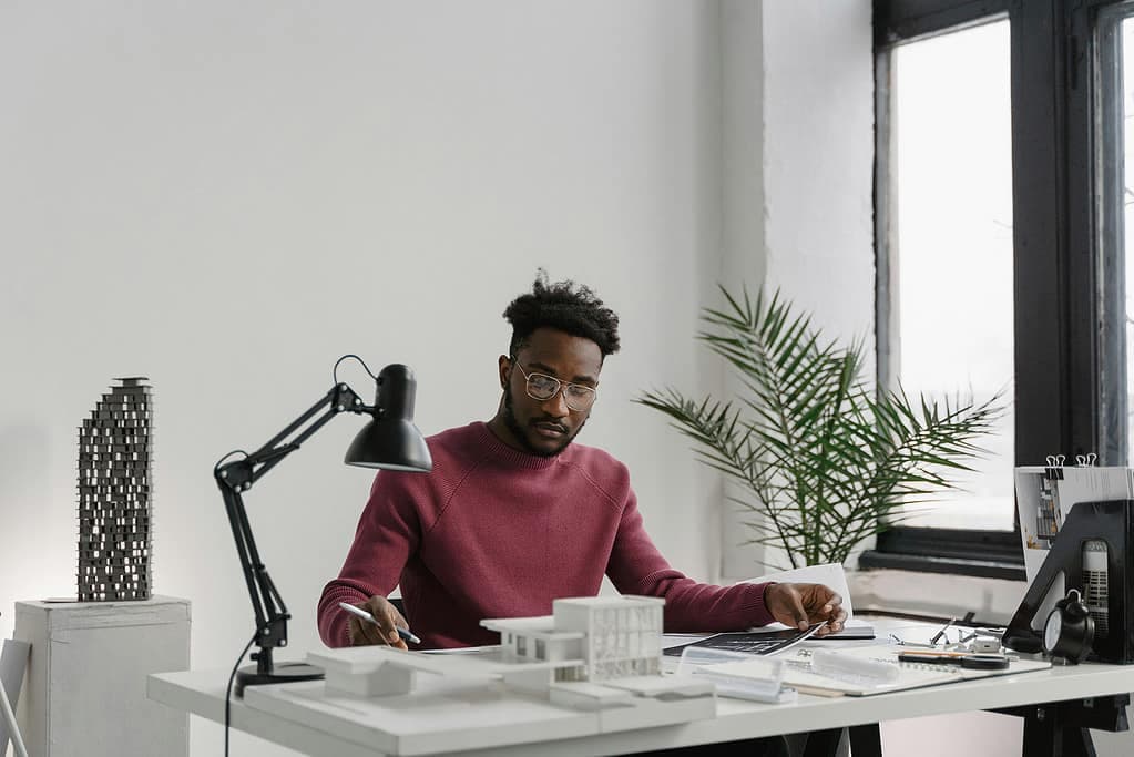 Architecture professional at desk with design materials